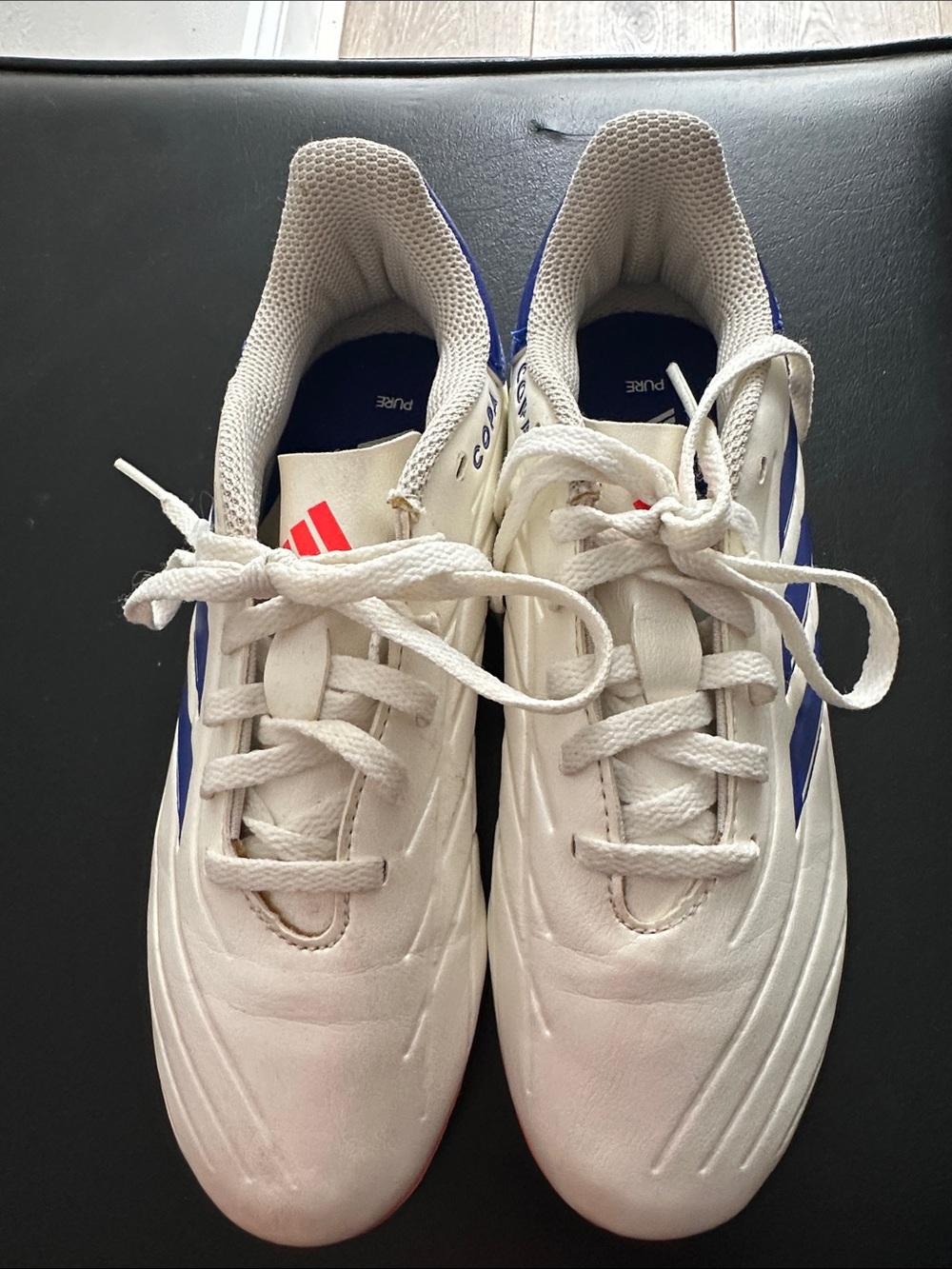 adidas kids White Athletic cleats with Blue Accents